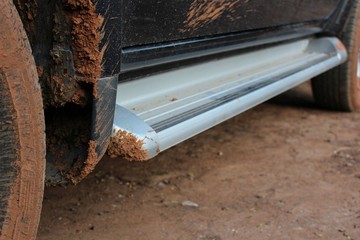 Mud soil stuck under the car's belly