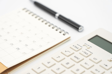 Flat lay of top view office table desk with Calendar, calculators pens and other office supplies as background Workspace and Comfortable work table concept with copy space.