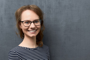 Portrait of happy girl with eyeglasses smiling broadly