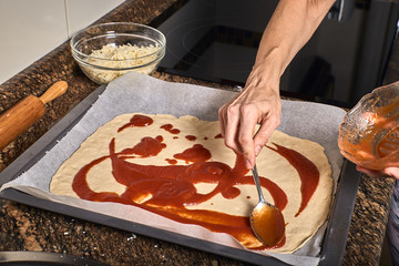 woman hands working on a pizza dough