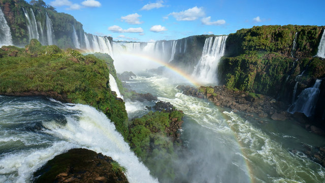 Iguazu Falls and rainbow on the Iguacu River. Located between Argentina and Brazil. Largest waterfalls system in the world.