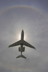 airplane flying through sundog