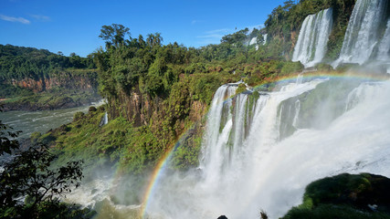 Cascade of Iguazu Falls with rainbow, Iguacu River. Located between Argentina and Brazil. Largest waterfalls system in the world.