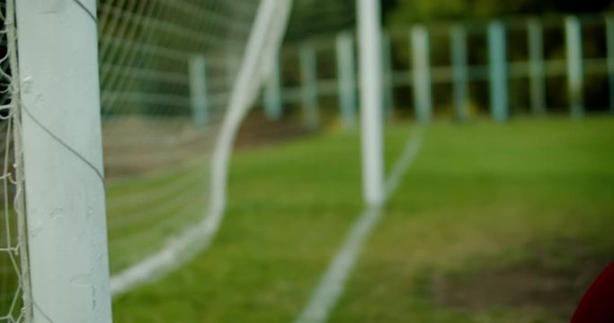 Young teenager girl soccer goalie fails to catch the ball during a match or practice. 4K UHD