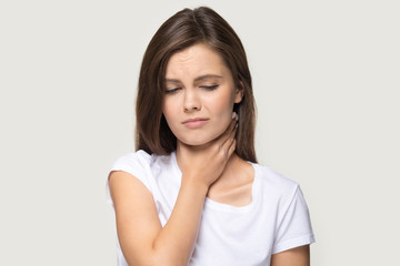 Head shot portrait woman touch neck feels pain in throat