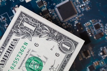 one dollar bill on motherboard background