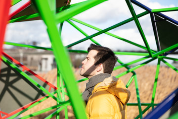 Man standing in geometric futuristic metal structure,