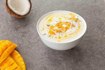 Mango smoothies bowl with coconut and Chia seeds. Vegan diet food concept. Healthy breakfast. 