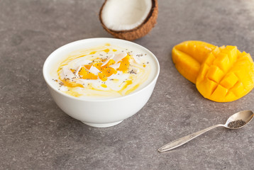 Mango smoothies bowl with coconut and Chia seeds. Vegan diet food concept. Healthy breakfast. 