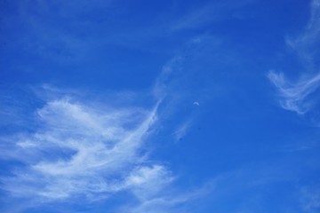 Brilliant Blue Sky with Clouds and the Moon