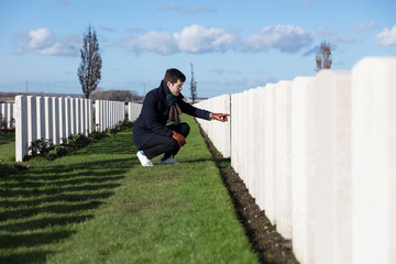 Man visiting grave of fallen soldier on Veterans Day