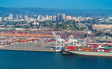 Oakland Harbor port terminal with cargo ship and shipping containers