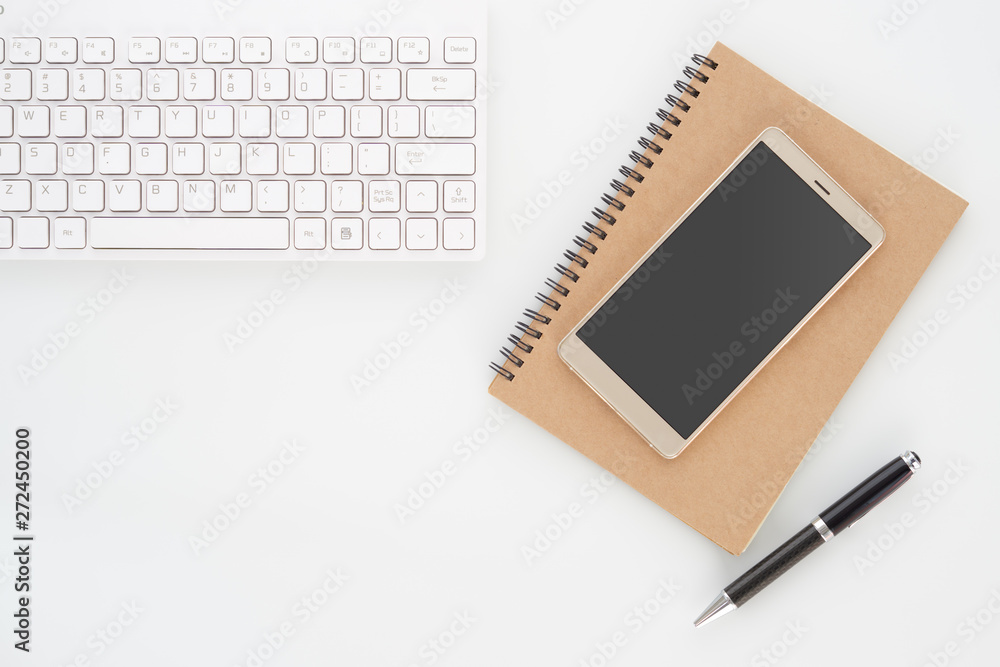 Aufkleber mock up blank screen of smartphone on notebook with pen and computer keyboard on white background. f