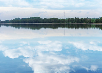 Beautiful view of the lake, clouds and trees. Spring, Mazury, Poland.