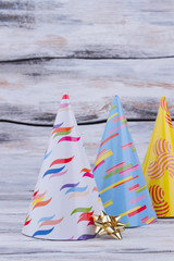 Party hats for Birthday celebration. Set of party cone hats on wooden background. Festive holiday accessory.