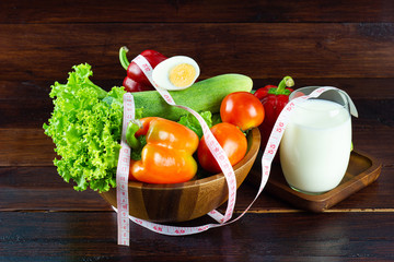 A green salad in wood cup consisting of a mixture With milk in a glass
