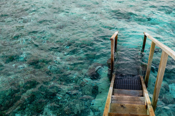 Fototapeta na wymiar Stairs of a water bungalow in the Maldives