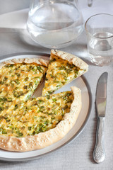 Tart with eggs and green onions on a plate
