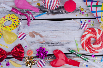 Obraz premium Birthday party accessories. Decorative items for party celebration on wooden background with copy space. Invitation for a holiday.