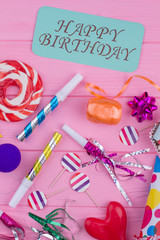 Colorful happy Birthday background. Birthday party accessories and card with handwritten inscription Happy Birthday, top view.