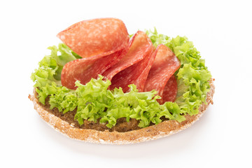 Sandwich with salami sausage on white background.
