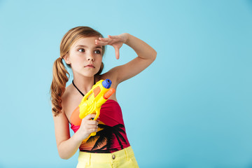 Cheerful little girl wearing swimsuit standing isolated