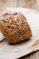 Gold rustic crusty loaves of bread and buns on wooden background. Still life captured from above top view, flat lay.