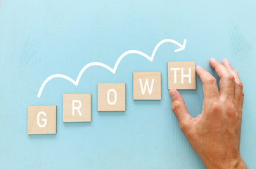 Hand arranging wood block stacking as chart or ladder. concept for growth and success