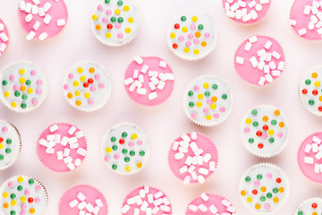 Colorful cupcakes on a white background.