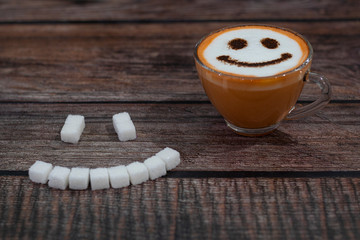 cup of hot Thai tea latte with sugar on a wooden background