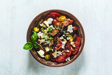 Italian traditional Tuscan panzanella salad with fresh tomatoes and cheese in clay plates. authentic Mediterranean healthy food