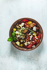 Italian traditional Tuscan panzanella salad with fresh tomatoes and cheese in clay plates. authentic Mediterranean healthy food