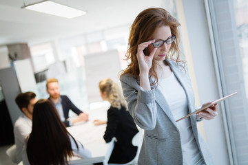 Portrait of attractive business partners using tablet