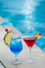 Two cocktails are placed on the edge of the pool.  This is a relaxing area of the resort in Phu Quoc island in Vietnam.
