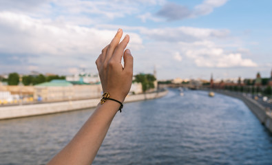 Woman's hand touch the sky.