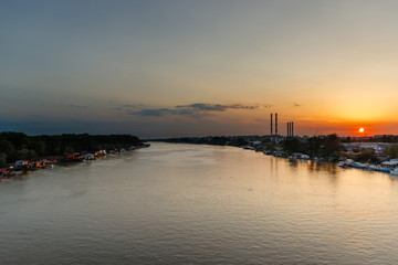 Fototapeta na wymiar Sunset at Sava river, sunset in industrial aerea of Belgrade
