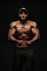 Obraz na płótnie Canvas Bodybuilding competitions on the scene. Man sportsmen bodybuilder physique and athlete. Fitness motivation.