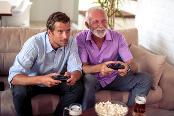 Men playing video game at home