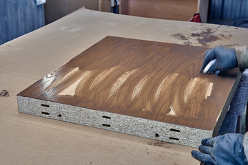 Staining veneer panels in painting chamber. Production of wood furniture. Furniture manufacture.
