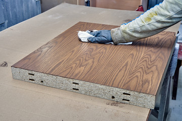 Staining veneer panels in painting chamber. Production of wood furniture. Furniture manufacture.