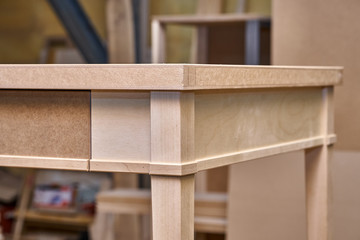 Fototapeta na wymiar Writing desk building process. Production of wood furniture. Furniture manufacture. Close-up