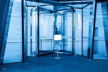 Rotating glass door in office building