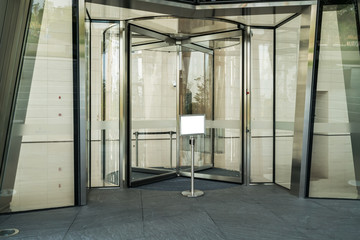 Rotating glass door in office building
