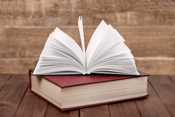 Ancient books in a row on wooden background