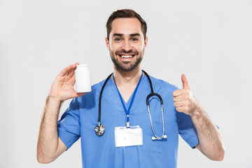 Attractive young cheerful male doctor wearing unifrom