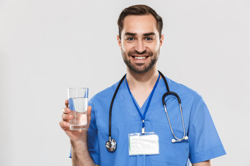 Attractive young cheerful male doctor wearing unifrom
