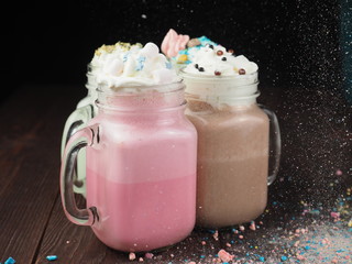 Tasty cocktails and sweets on a wooden table