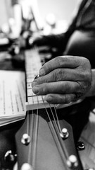 Arthritic hands playing the guitar weathered old hands playing music