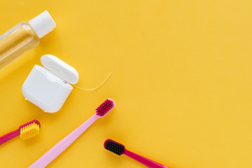 Dental hygiene - tooth brushes, dental floss, mouthwash flat lay, top view, copy space, yellow...
