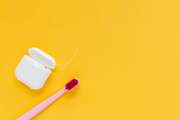 Dental hygiene - tooth brush flat lay, top view, copy space, yellow background